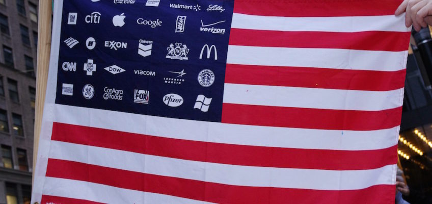 Photo: A U.S. flag with corporate logos.