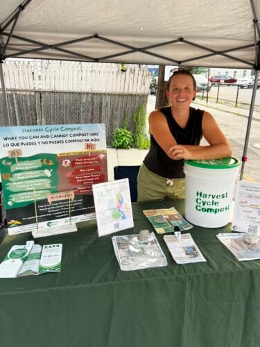 Harvest Cycle Director Ella doing outreach at Smith Hill Block Party. Credit: Carla Doughty
