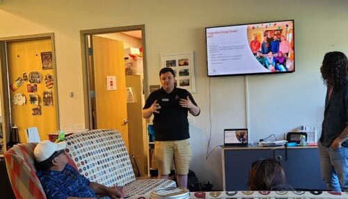A Cooperative Energy Futures staff member presents community solar program details to residents in a manufactured home community.