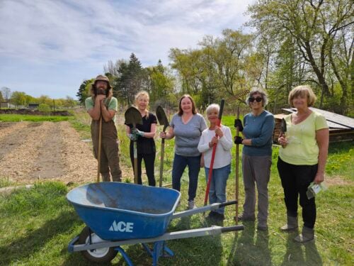 Volunteers from Father Fred Foundation in partnership with SEEDS staff on the SEEDS Farm to spread finished compost for growing produce. Credit: SEEDS